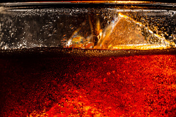 Macro cola and ice,Cola with Ice. Food background,Close up view of the ice cubes in cola background 