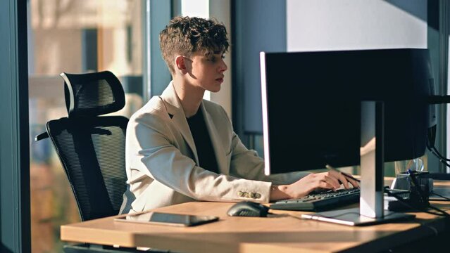 Young man is working in a computer in an office