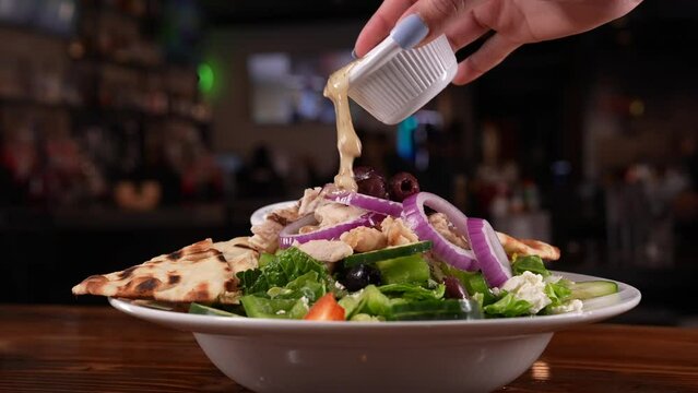pouring dressing salad in a bowl, stock footage, 4k
