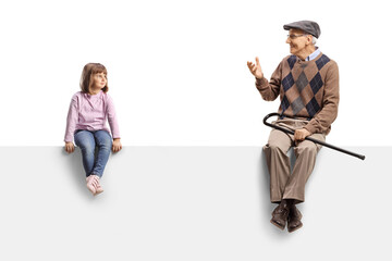 Girl sitting on a blank panel and listening to grandfather