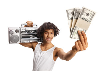 African american young man holding a boombox on shoulder and showing stacks of money