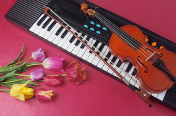 Electric guitar, synthesizer keyboard, maracas and a bouquet of tulips and lilies of the valley on...