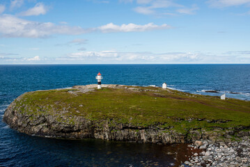 Beautiful natural landscape of Norway with a lighthouse. Scenic outdoor view. Ocean with waves and mountains. Explore Norway, Lofoten Islands