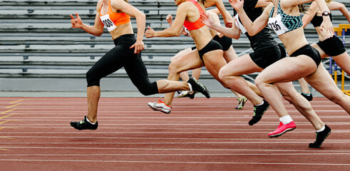group of women sprinters run race in athletics competition