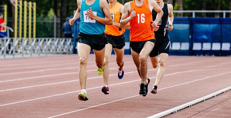 male runners run in stadium middle ditsance in athletics