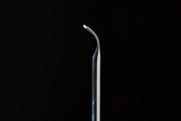 Stainless Steel Ear Pick Earwax Removal tools macro in isolated black background