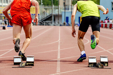 two runners athletes start from starting blocks