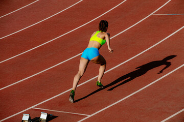 start 400 meters young woman runner run in stadium