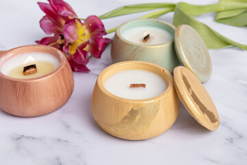 Fototapeta na wymiar Soy wax candles in plaster candlesticks. Handmade business. Different candles. Decorating with potal
