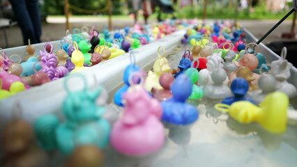 Rubber ducks at pool amusement park. fishing game at funfair festival party