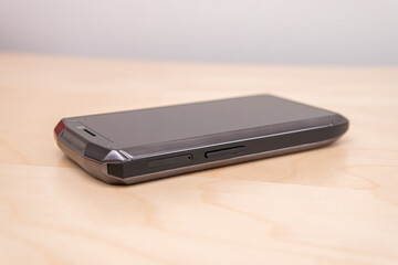 Concept of a smartphone design. Tiny smartphone on a table. 