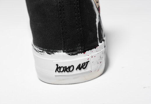 KENT, UK, 01.01.2023 KOKO ART Wednesday Addams family movie inspired  scary goth horror converse style canvas trainer shoes. Famous iconic classic converse hi top sneakers on a white background.