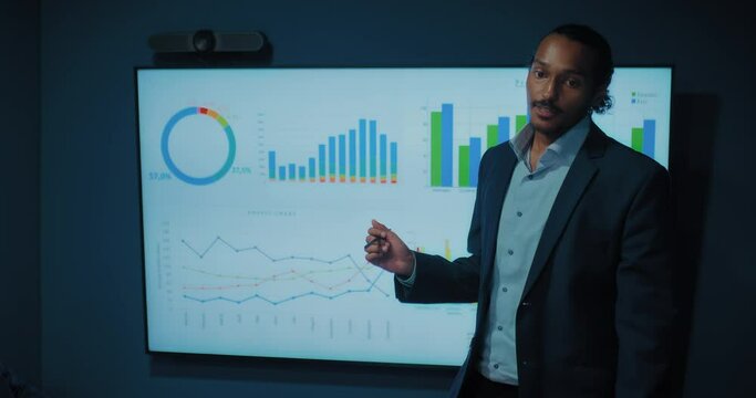 african american business coach speaking in conference, man showing charts, portrait, 4K, Prores