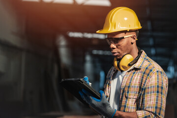 workshop male worker using online wireless tablet technology for computer aided design helping at...