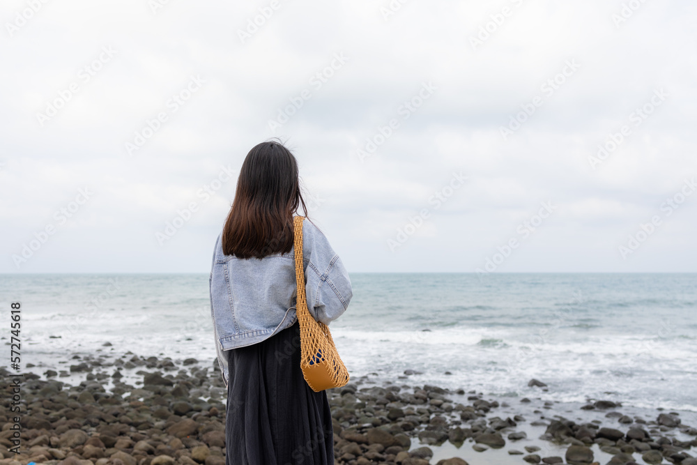 Wall mural woman look at the sea beach