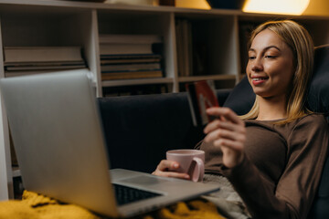 Young Caucasian woman is using her credit card for online payment