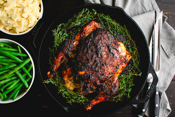 Apple Butter Roasted Chicken Served with Vegetable Side Dishes: Roast chicken in a cast iron pan with mashed potatoes and green beans