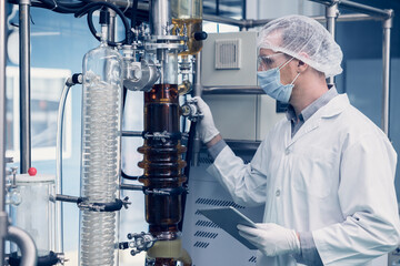 Scientist man working Cannabis CBD oil extraction for medical Science lab. Hemp oil extraction Thin...