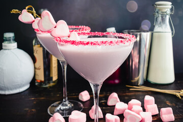 Raspberry and White Chocolate Valentine Cocktail: Pink cocktail in a martini glass rimmed with...