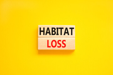 Habitat loss symbol. Concept words Habitat loss on wooden block. Beautiful yellow table yellow background. Business habitat loss concept. Copy space.