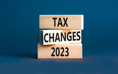 Tax changes 2023 symbol. Concept words Tax changes 2023 on wooden blocks on a beautiful grey table grey background. Business Tax changes 2023 concept. Copy space.