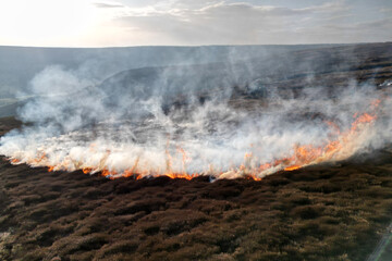 Fototapeta premium aerial view of farm crops on fire, global warming , heatwave and drought