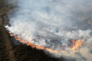 aerial view of farm crops on fire, global warming , heatwave and drought