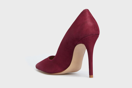 Burgundy pointy toe women's shoe with high heels isolated on white background. Female classic stiletto heels in suede leather. Behind view. Mock up, template