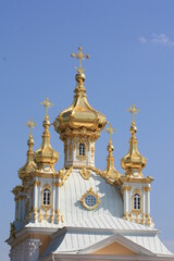Fototapeta na wymiar Church cross in gold color. Christian faith. Religious building, building for the worship of God. Religious tourism