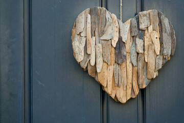 boho front door decoration of heart shape covered with driftwood pieces