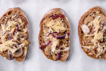 Delicious crispy toast or bruschetta with fried onion, champignon mushrooms and cheese