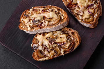 Delicious crispy toast or bruschetta with fried onion, champignon mushrooms and cheese