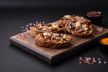 Delicious crispy toast or bruschetta with fried onion, champignon mushrooms and cheese