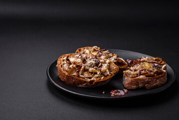 Delicious crispy toast or bruschetta with fried onion, champignon mushrooms and cheese
