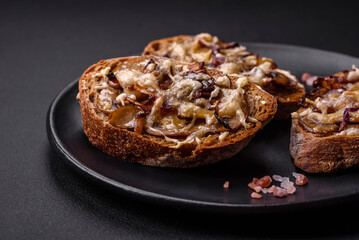 Delicious crispy toast or bruschetta with fried onion, champignon mushrooms and cheese