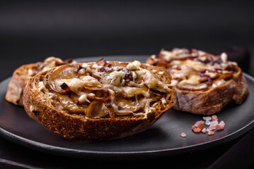 Delicious crispy toast or bruschetta with fried onion, champignon mushrooms and cheese