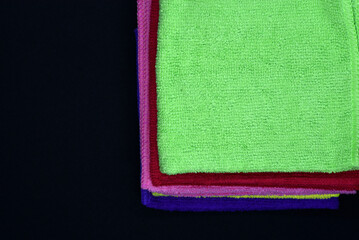 Terry towels on a dark background. Colorful wiping cloths. Terry napkins.