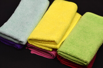 Terry towels on a dark background. Colorful wiping cloths. Terry napkins.