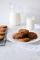 Close-up of homemade cookies on a plate against the background of milk