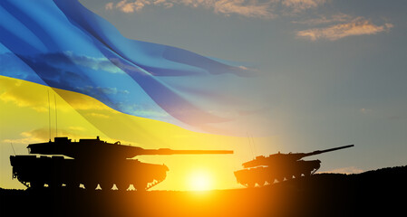 Silhouettes of army tanks at sunset sky background with Ukrainian flag. Shipping a huge,...