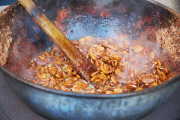 Roasting almonds in a cauldron in Denmark