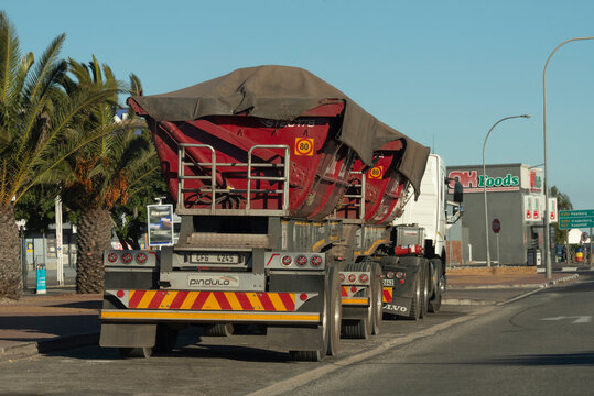 Velddrif, Western Cape, South Africa. 2023. Truck with side tipping trailers parked on roadside in Velddrif.