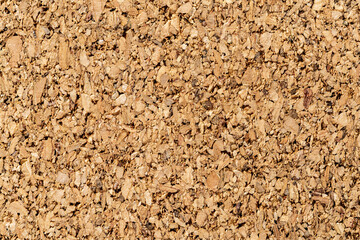 Brown cork texture macro. Background of corkboard surface for paper notes and memo stickers. Grainy wood material of the cork oak bark. Cork board concept. Full frame.
