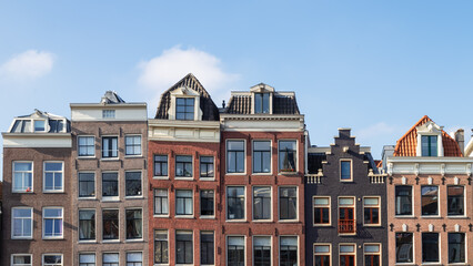 Canal houses with different facades next to each other in the center of Amsterdam.