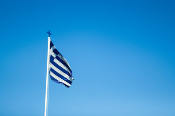 A Greece flag on a background of blue sky in nature
