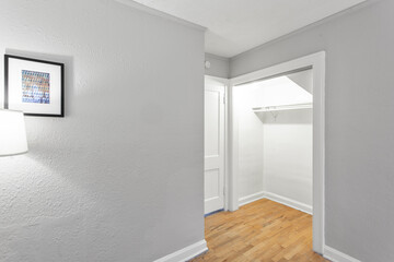 Large walk-in master bedroom closet in a new construction house with hardwood floors and wire shelving