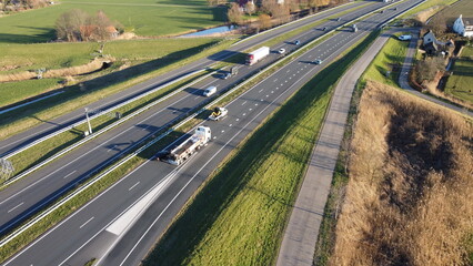 Highway seen from the air in the Netherlands captured with drone. Travel and move, connection with traffic jam and passage with progress. Safety on asphalt with entrance and exit.