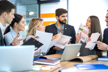 Group of business people holding documents with financial statistic reports and showing them to each other. Stock market, finance, marketing, development, economics, money and financial concept.