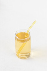Homemade kombucha fermented drink in glass and straw on white