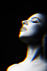 Beautiful woman studio portrait with fancy earrings blowing smoke through mouth. Model looking up with partly closed eyes. RGB channel color split effect applied. Futuristic looking style